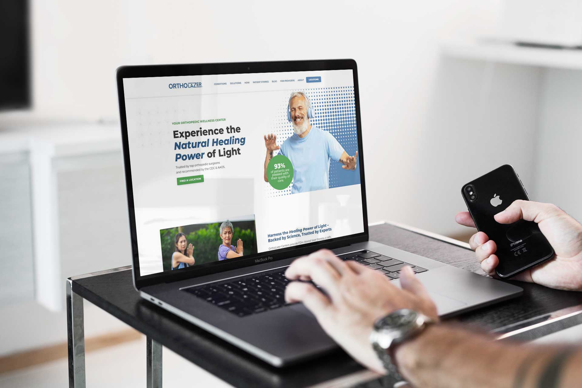 Person using a laptop on Lake City Restorations site about natural healing with light.